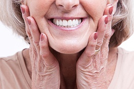 woman smiling after getting dentures 