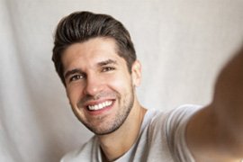 Man smiling while talking a selfie