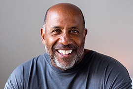 Senior man smiling in gray shirt