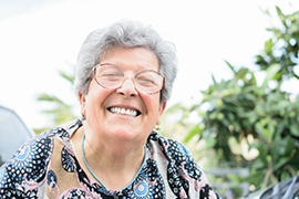 Woman smiling brightly while enjoying the outdoors