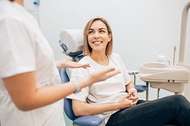 Dentist converses with patient