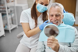 man smiling in dental mirror 