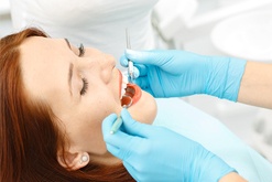 Relaxed woman receiving dental care