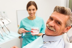 Smiling senior man in dental chair