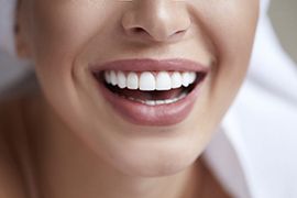 Closeup of woman smiling with straight, white, flawless teeth