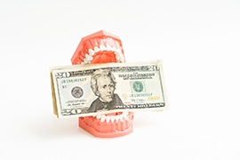 Money being held in a set of teeth