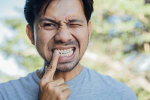 person pointing a tooth that hurts