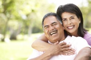 Smiling older couple with dental implants in Corpus Christi