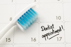 Toothbrush and dental appointment on calendar