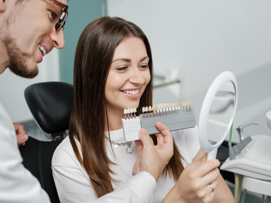 Dentist showing patient in chair veneer options