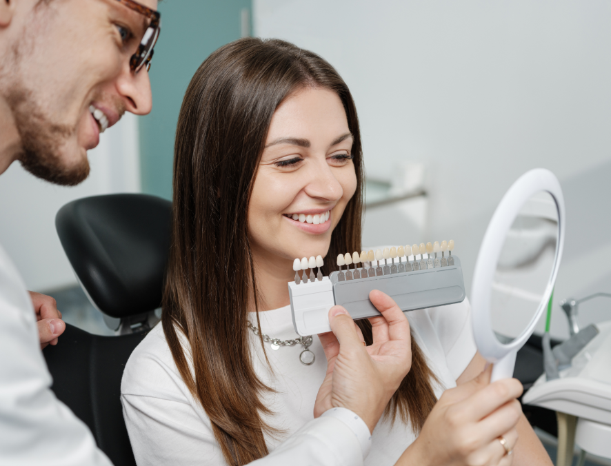 Dentist showing patient veneer options